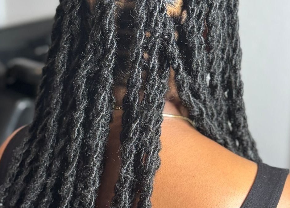 Intricate black locs styled at Loc’d In Hair Studio, St. Catherine, JM, showcasing expert craftsmanship.