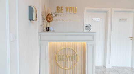 Reception area of Be You Leeds, featuring elegant decor and award display. Located in Leeds, England, GB.