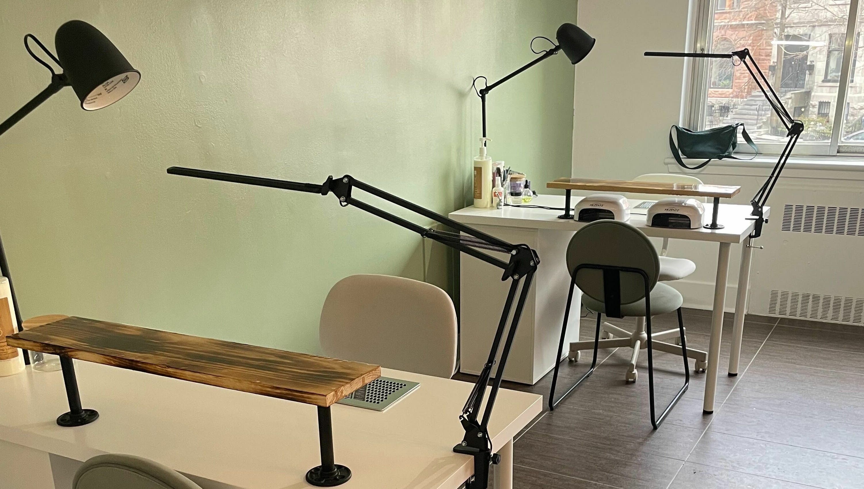 Elegant nail workstations in Studio Kay Belle, Montréal, Québec, CA with modern lighting and decor.