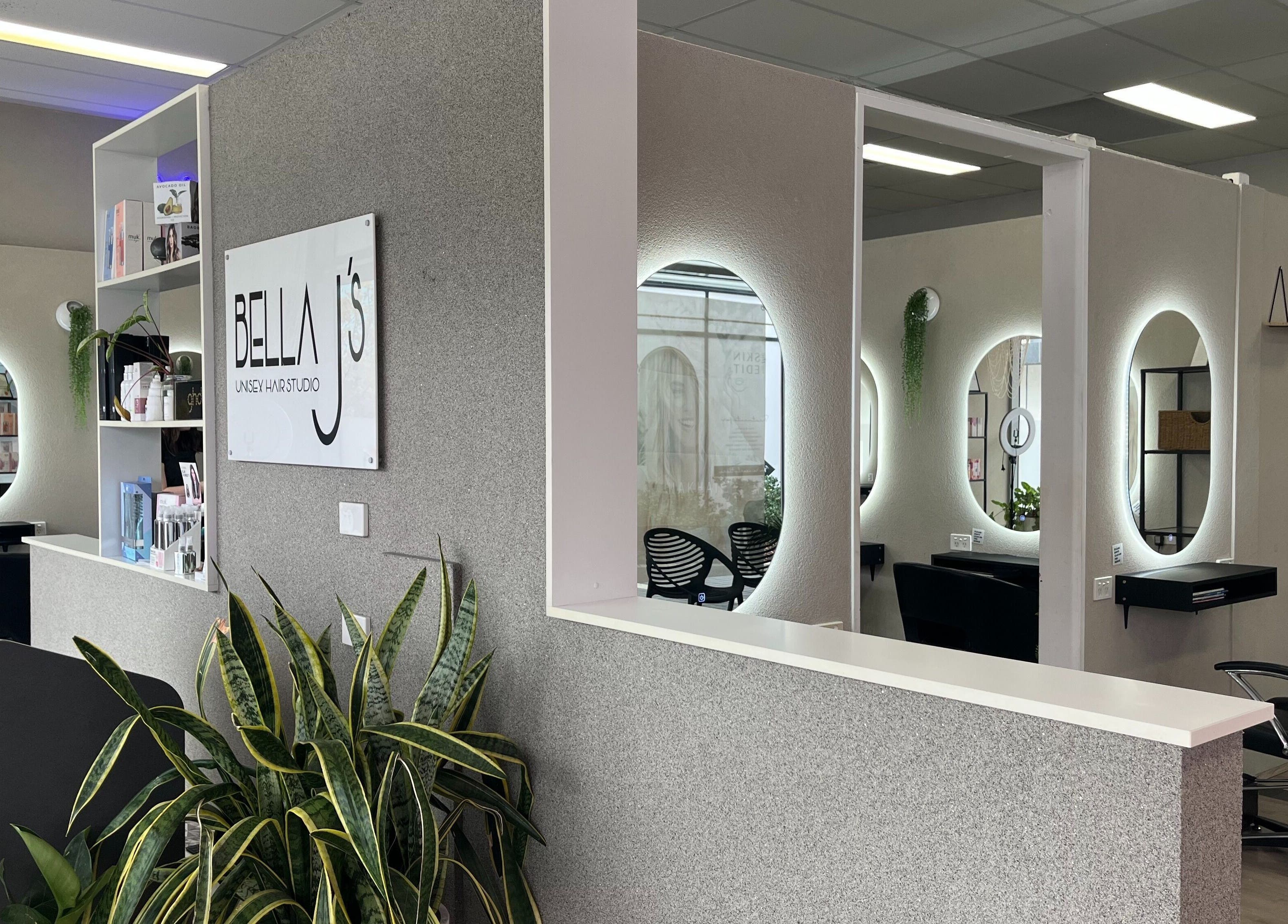 Modern interior of Bella J's Unisex Hair Studio, Alkimos, WA, featuring stylish mirrors and lush greenery.