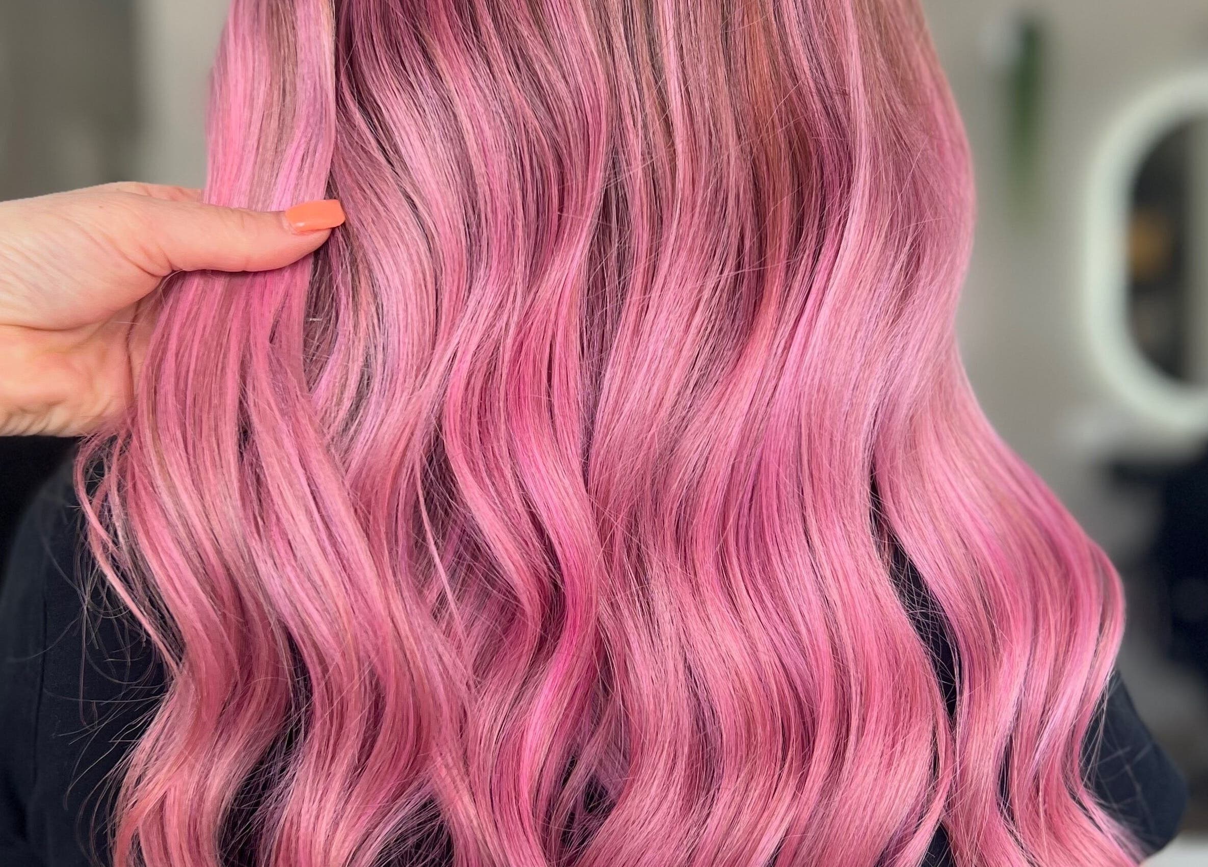 Vibrant pink wavy hairstyle at Bella J's Unisex Hair Studio, Alkimos, Western Australia, AU.