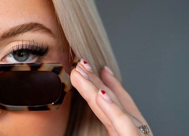 Close-up of a woman's eye with sunglasses at Blade to Brows | S&S Beauty House, Oakville, Ontario, CA.