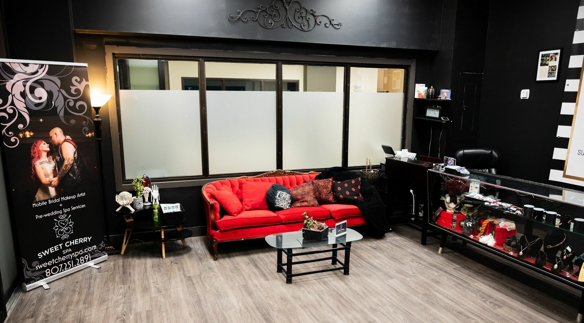 Welcoming interior of Sweet Cherry Spa, Thunder Bay, Ontario, CA featuring red couch and elegant decor.