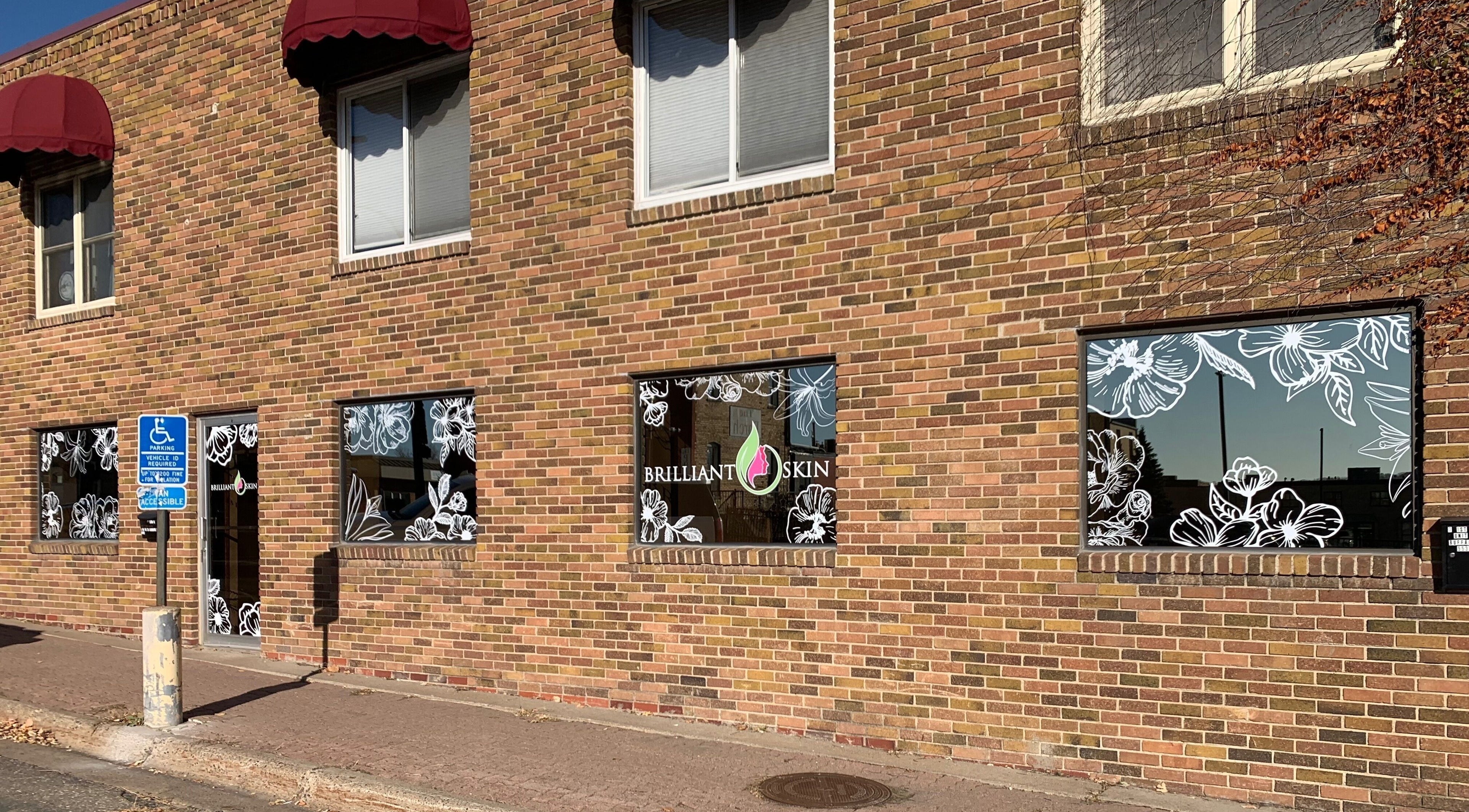 Exterior of Brilliant Skin in Buffalo, Minnesota, US with floral window design.