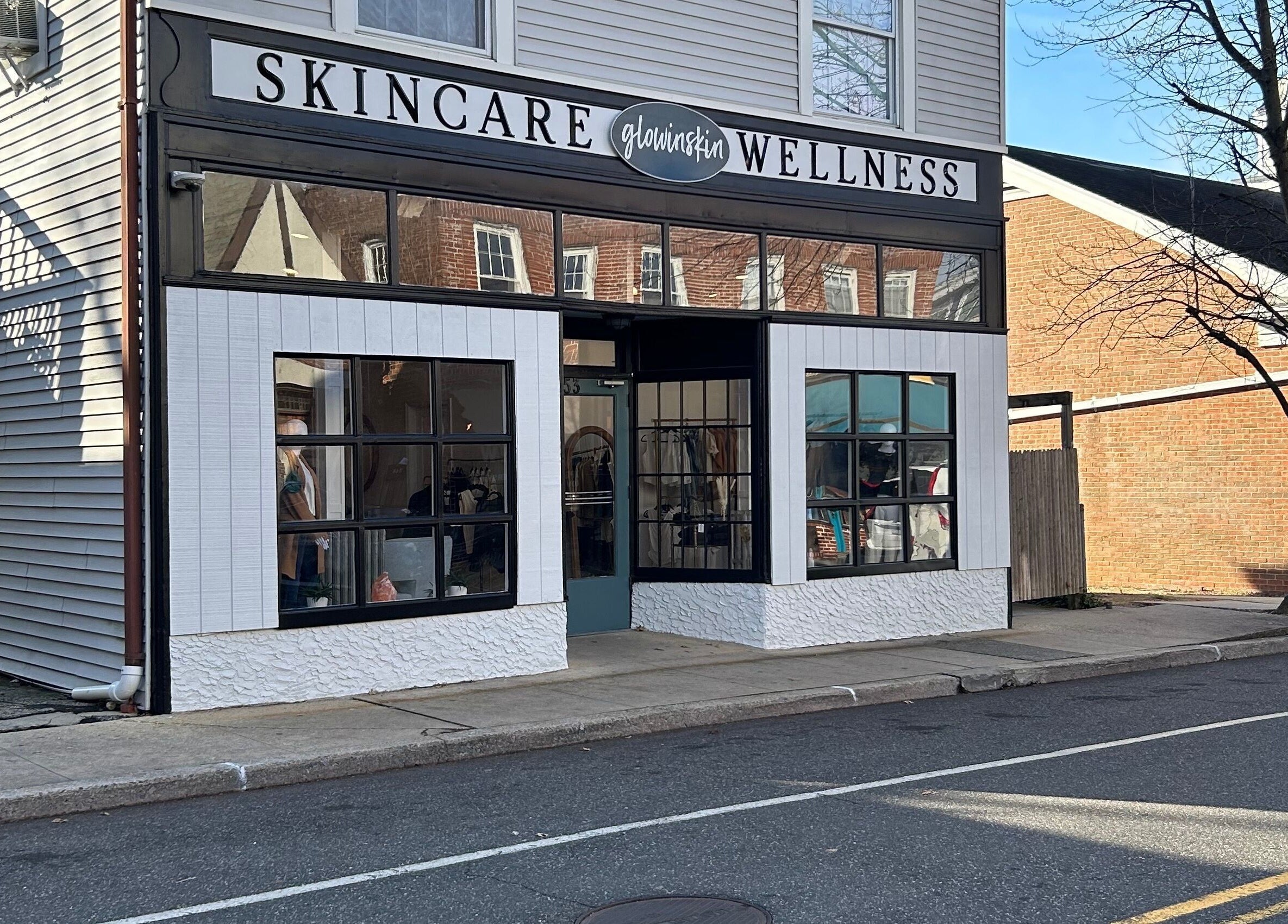 Exterior view of Glowinskin Esthetics, Sea Cliff, New York, showcasing skincare and wellness signage.