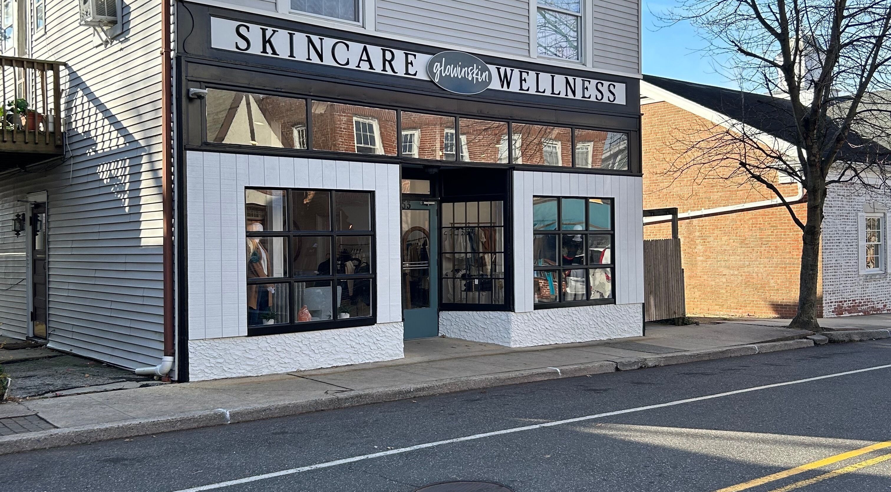 Exterior view of Glowinskin Esthetics, Sea Cliff, New York, showcasing skincare and wellness signage.