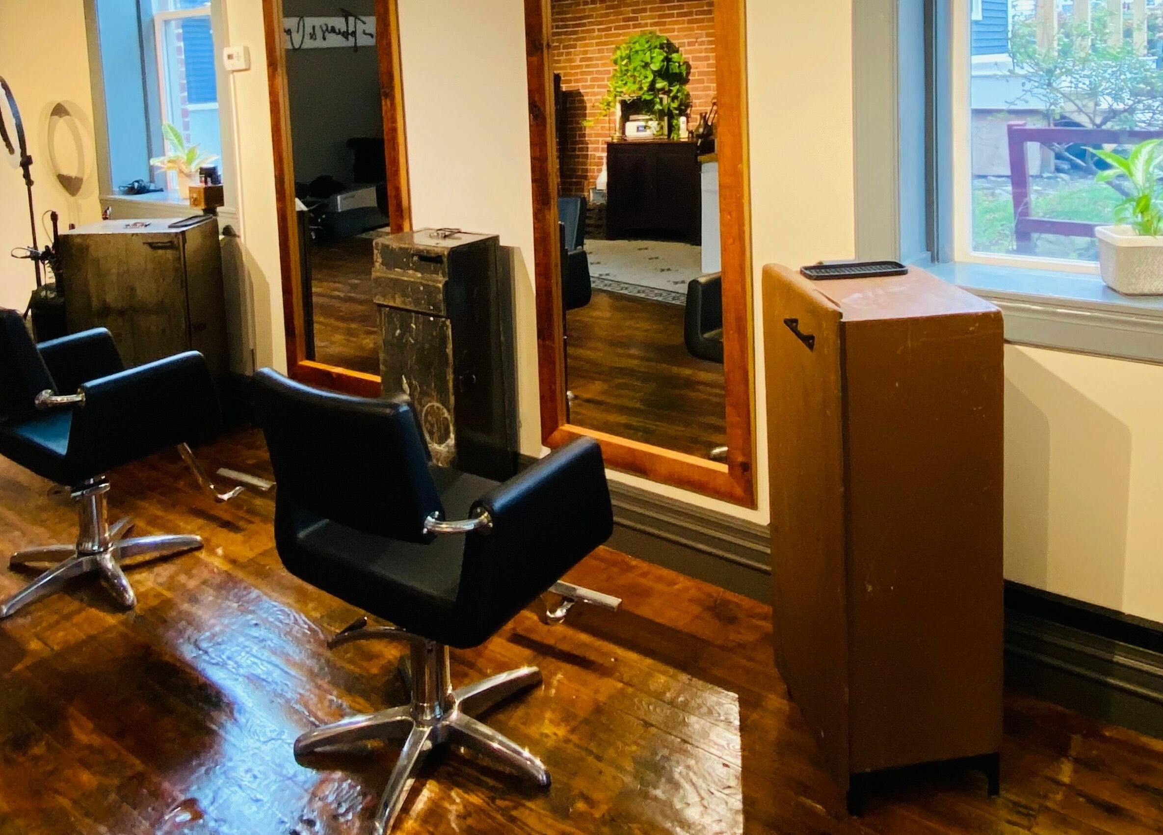 Contemporary salon interior at Tobias & Co. Salon, Hammondsport, New York, US with stylish chairs and mirrors.