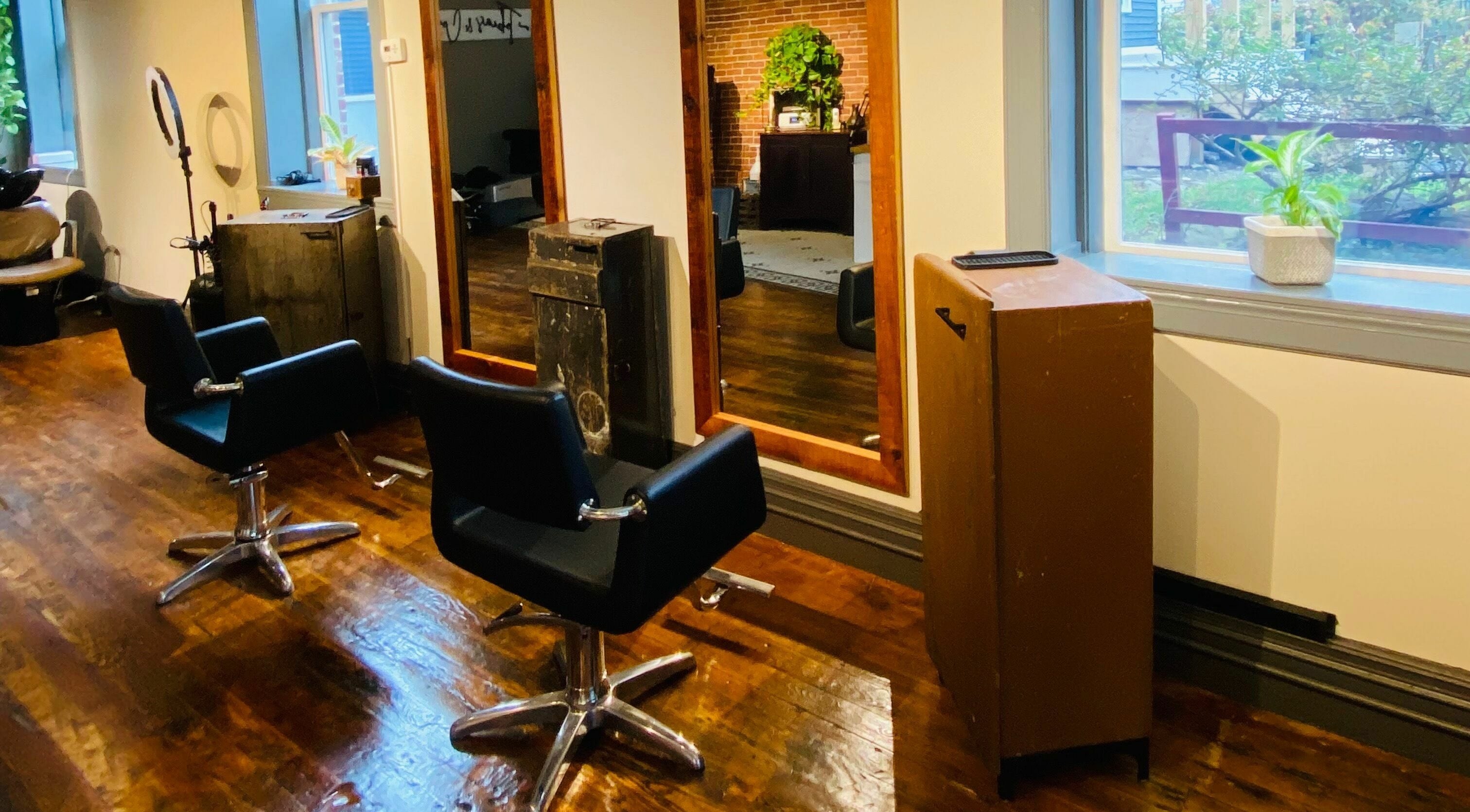 Contemporary salon interior at Tobias & Co. Salon, Hammondsport, New York, US with stylish chairs and mirrors.