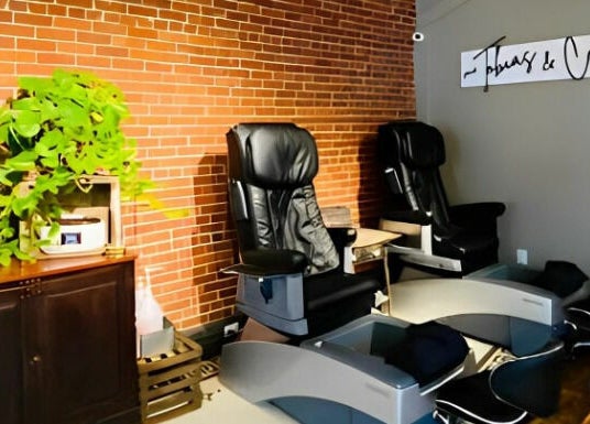 Relaxing pedicure chairs at Tobias & Co. Salon, Hammondsport, New York, US, with lush plants decor.
