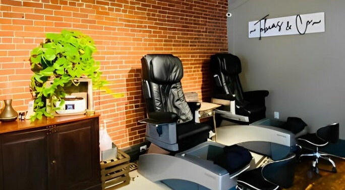 Relaxing pedicure chairs at Tobias & Co. Salon, Hammondsport, New York, US, with lush plants decor.