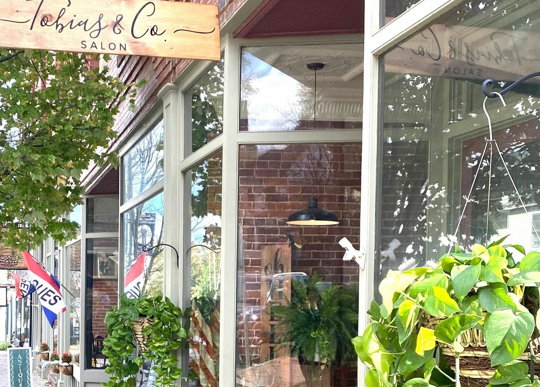Tobias & Co. Salon entrance with lush greenery, Hammondsport, New York, US.