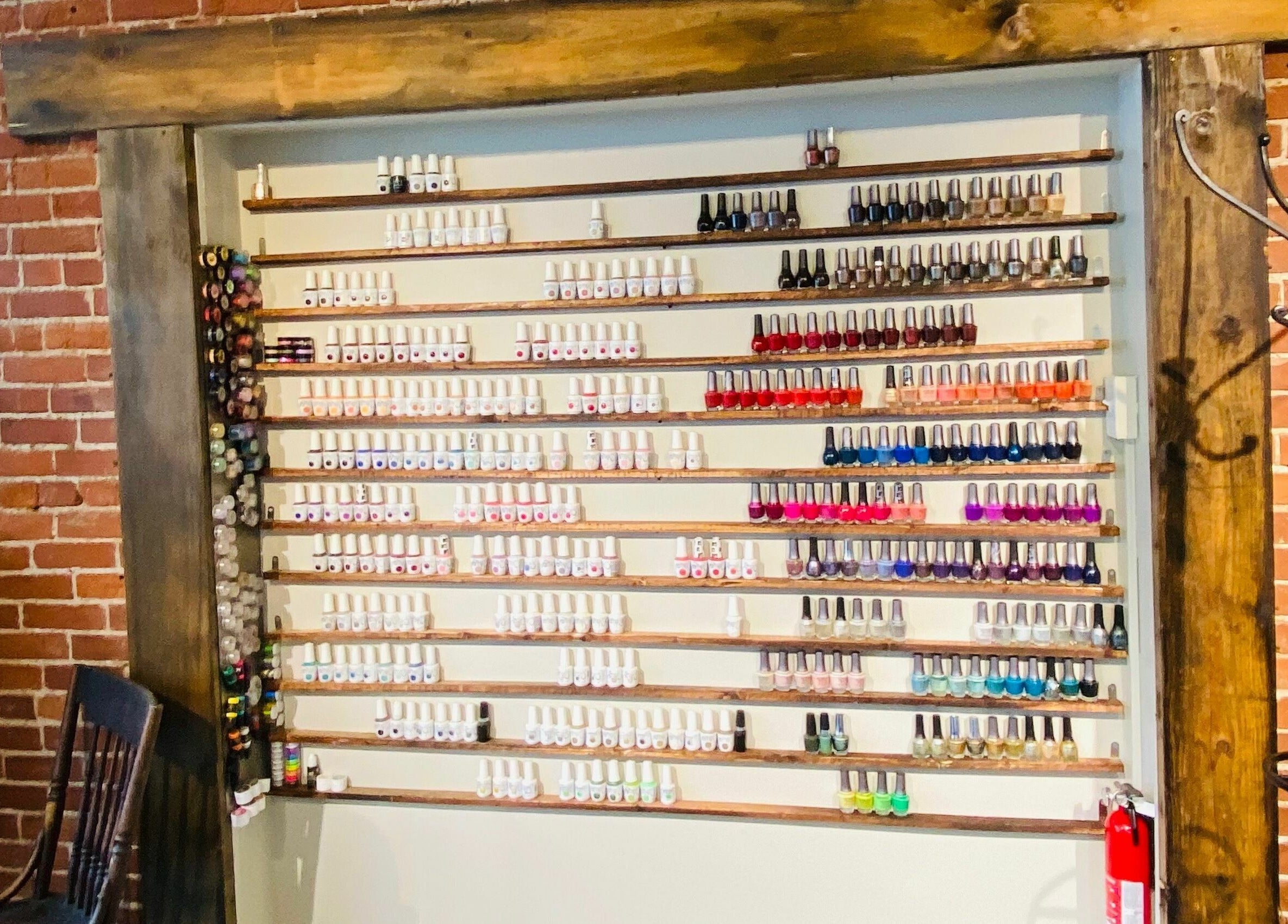 Colorful nail polish wall at Tobias & Co. Salon, Hammondsport, New York, US, offering diverse color options.