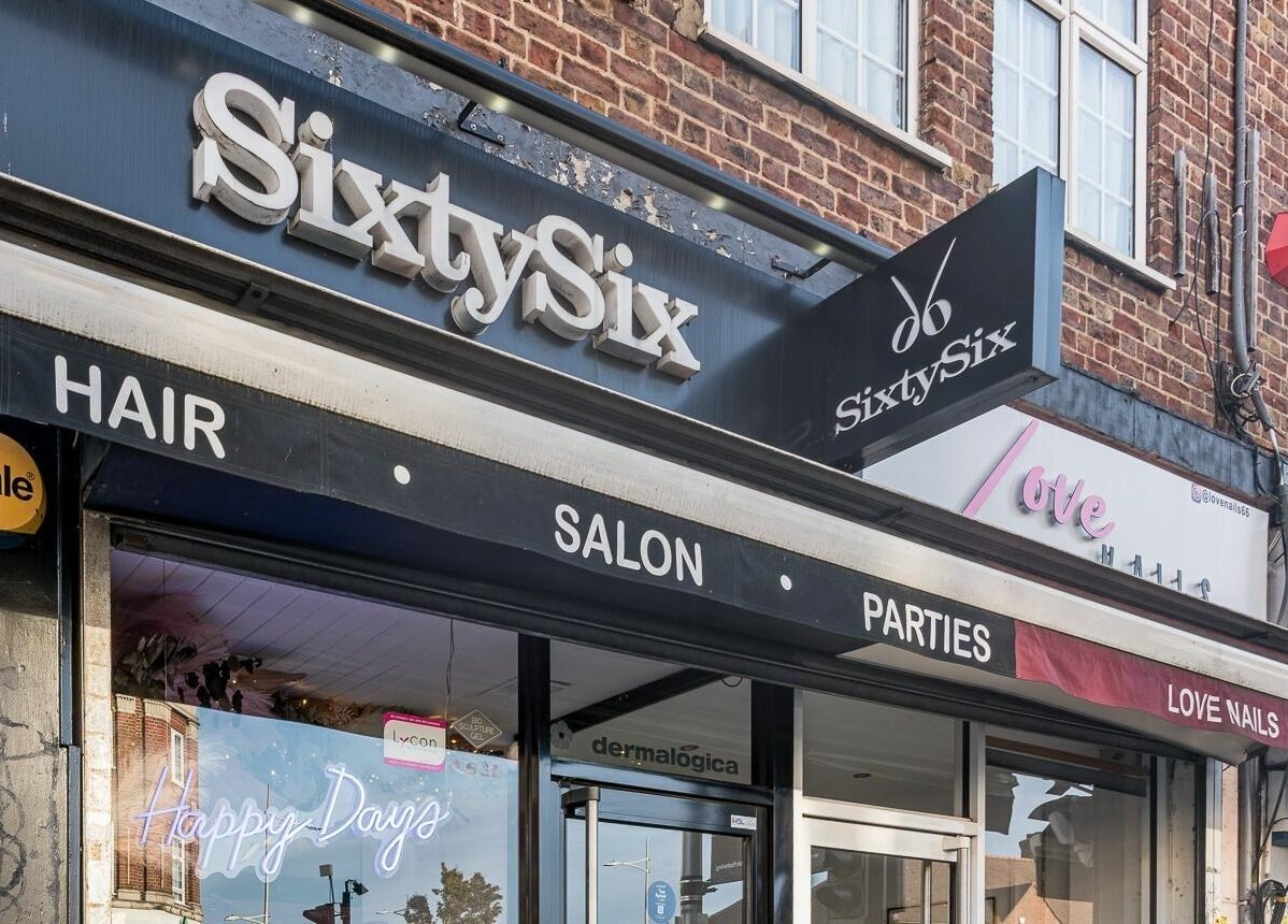 Exterior of SixtySix beauty salon in Ilford, England, GB, showcasing modern signage and attractive storefront.