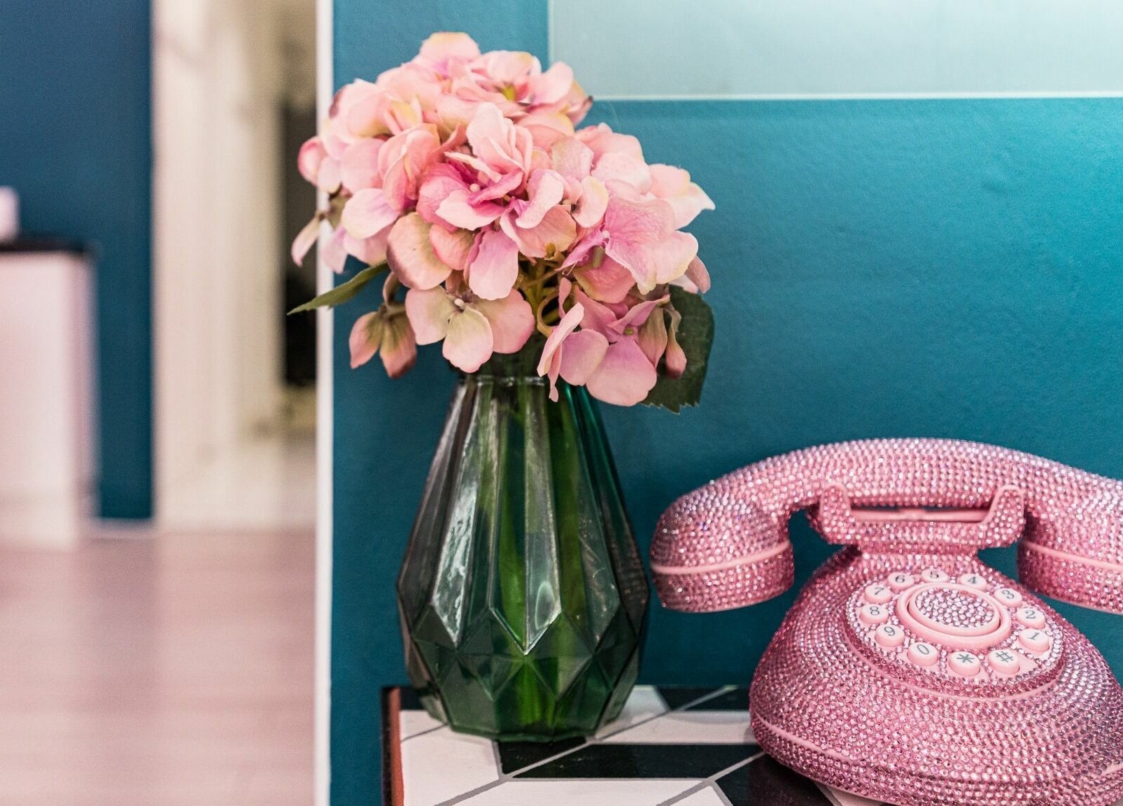 Vintage pink rotary phone and flowers at SixtySix, Ilford, England, GB, adding chic retro elegance.