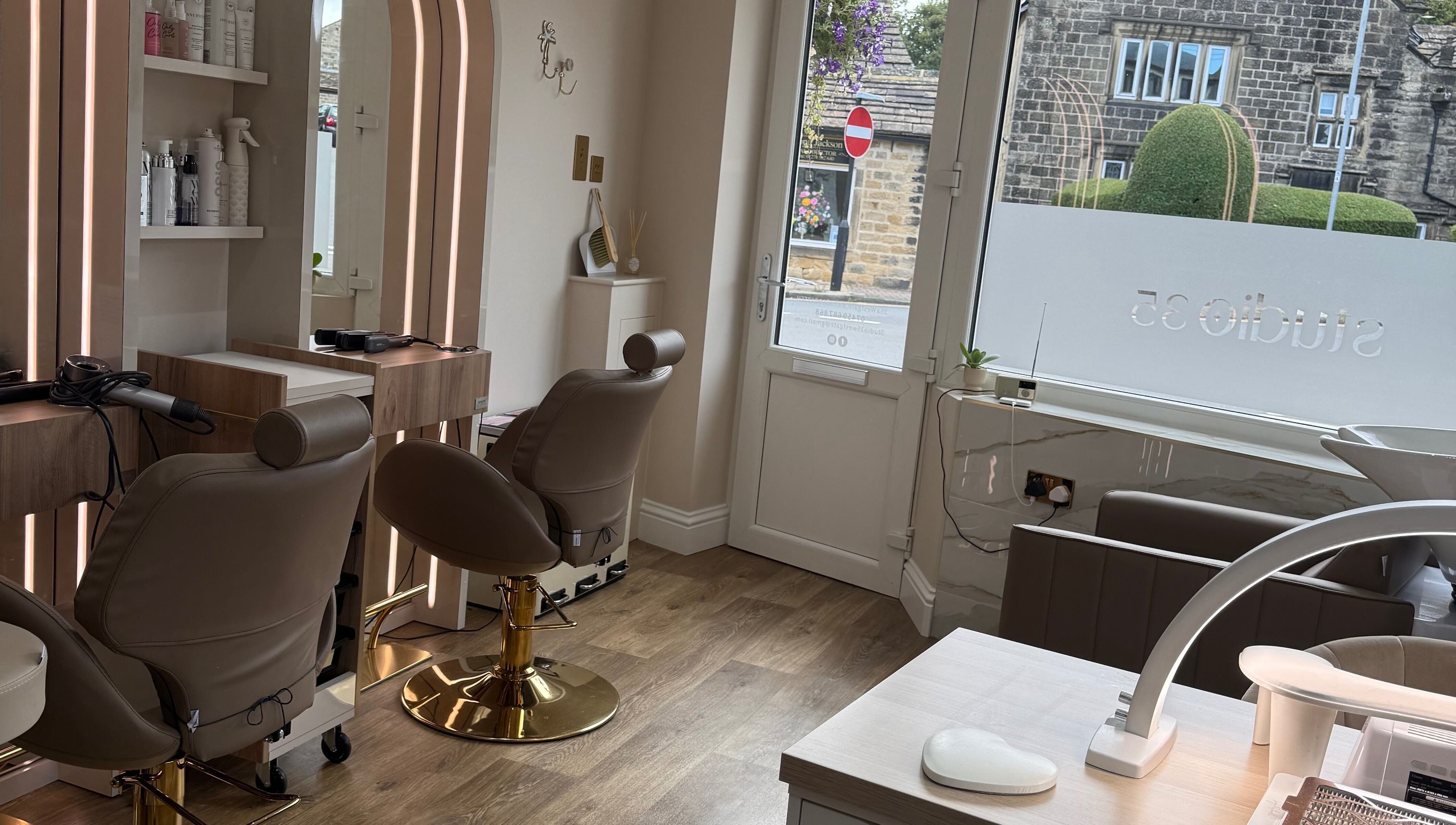 Stylish interior of Studio 35, a beauty venue in Baildon, England, GB, showcasing luxury chairs and decor.