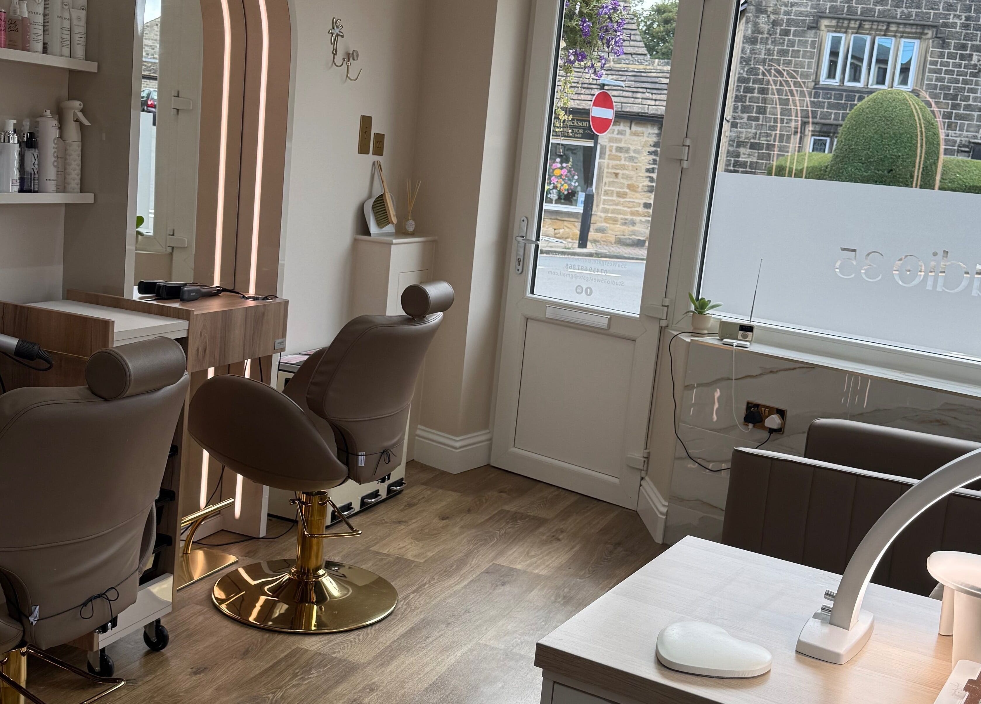 Stylish interior of Studio 35, a beauty venue in Baildon, England, GB, showcasing luxury chairs and decor.