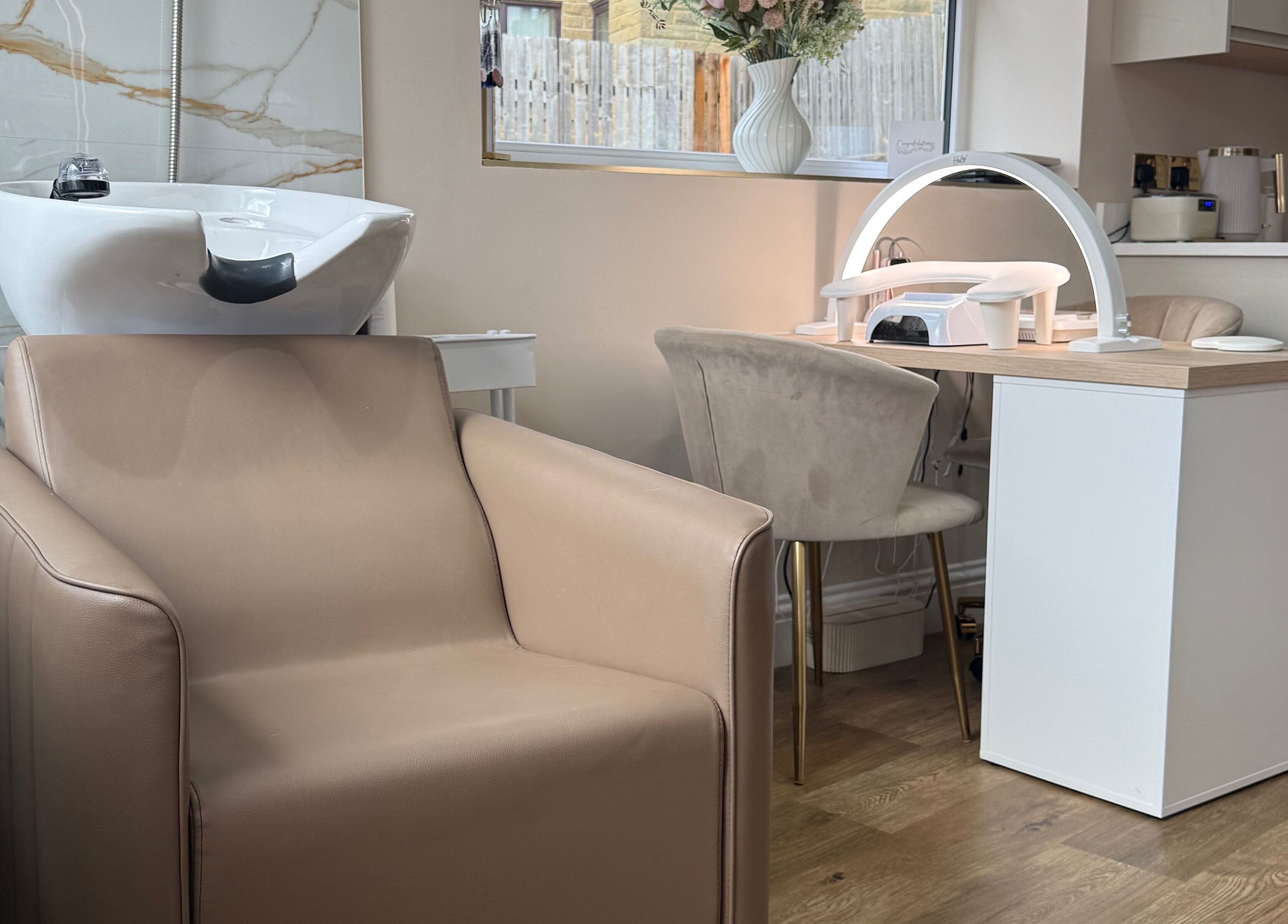 Studio 35 salon interior in Baildon, England, GB with chic beige seating and modern beauty station.