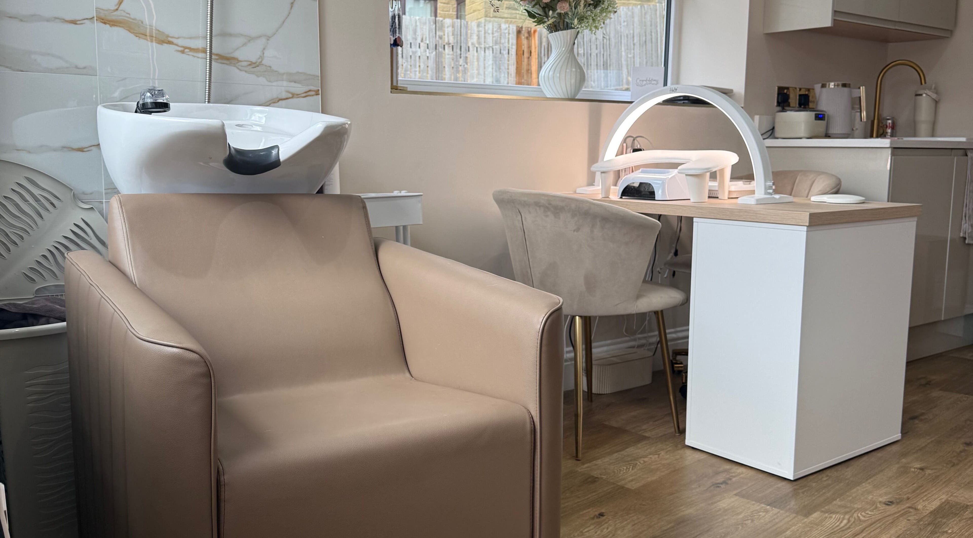 Studio 35 salon interior in Baildon, England, GB with chic beige seating and modern beauty station.