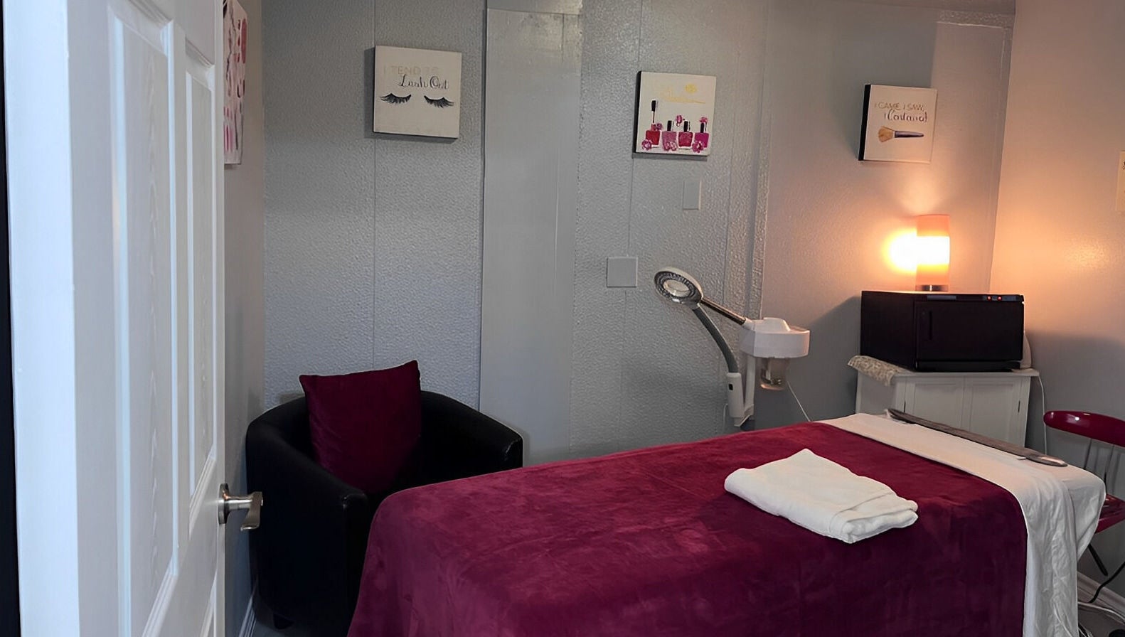 Cozy treatment room at Flawless Spa Retreat of Distinction, Live Oak, Texas, US with plush bed and ambient lighting.