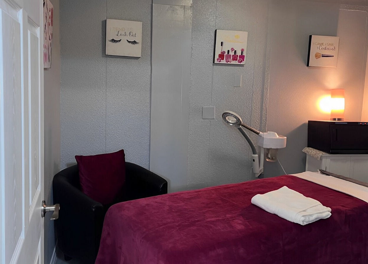 Cozy treatment room at Flawless Spa Retreat of Distinction, Live Oak, Texas, US with plush bed and ambient lighting.