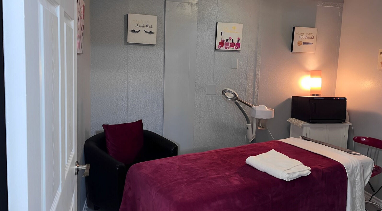 Cozy treatment room at Flawless Spa Retreat of Distinction, Live Oak, Texas, US with plush bed and ambient lighting.