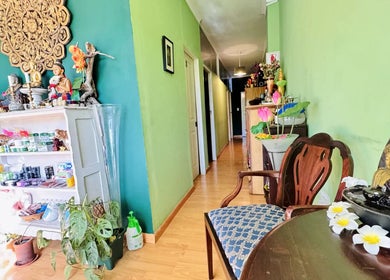 A tranquil lobby at Rabeang Mai Thai Massage Therapy, Cape Town, Western Cape, ZA, with decor and seating.
