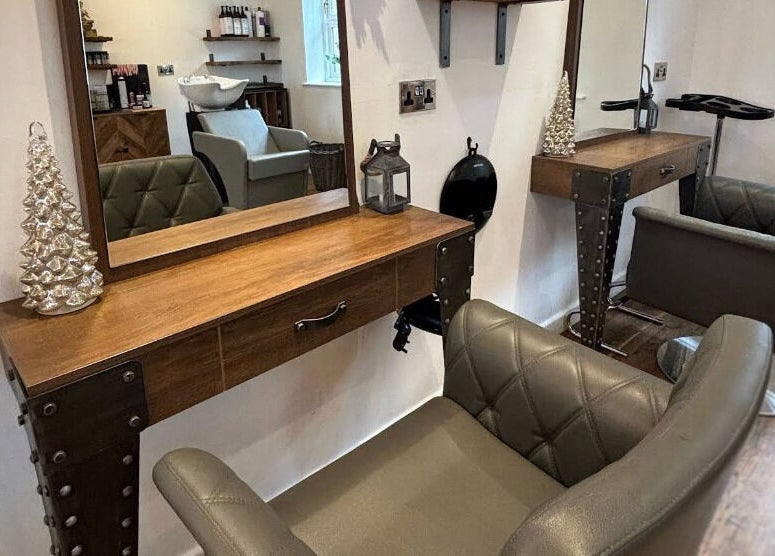 Elegant styling station at Dawn Furness at Okra Salon, Bedlington, England, GB, featuring plush chairs.