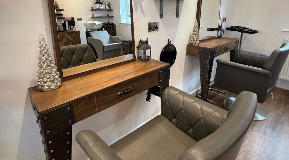 Elegant styling station at Dawn Furness at Okra Salon, Bedlington, England, GB, featuring plush chairs.