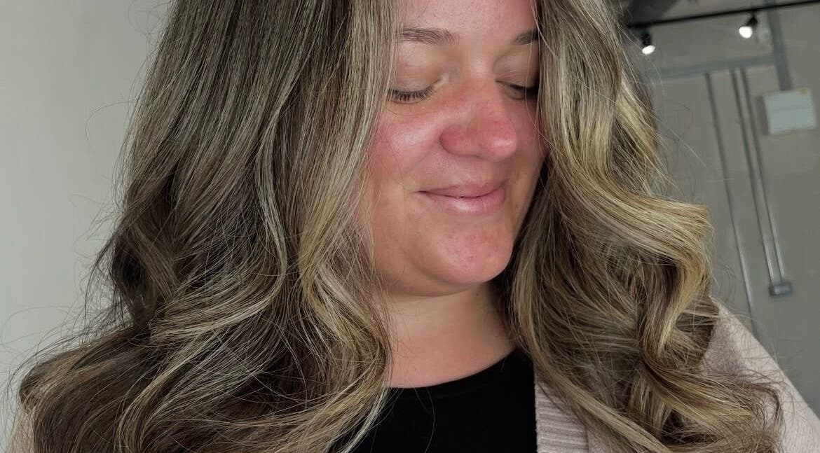 Woman with stylish curls at Chloe Jade Hair, Rogerstone, Newport, GB.