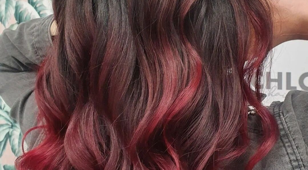 Chic red balayage hairstyle at Chloe Jade Hair, Rogerstone, Newport, GB. Vibrant and trendy salon style.