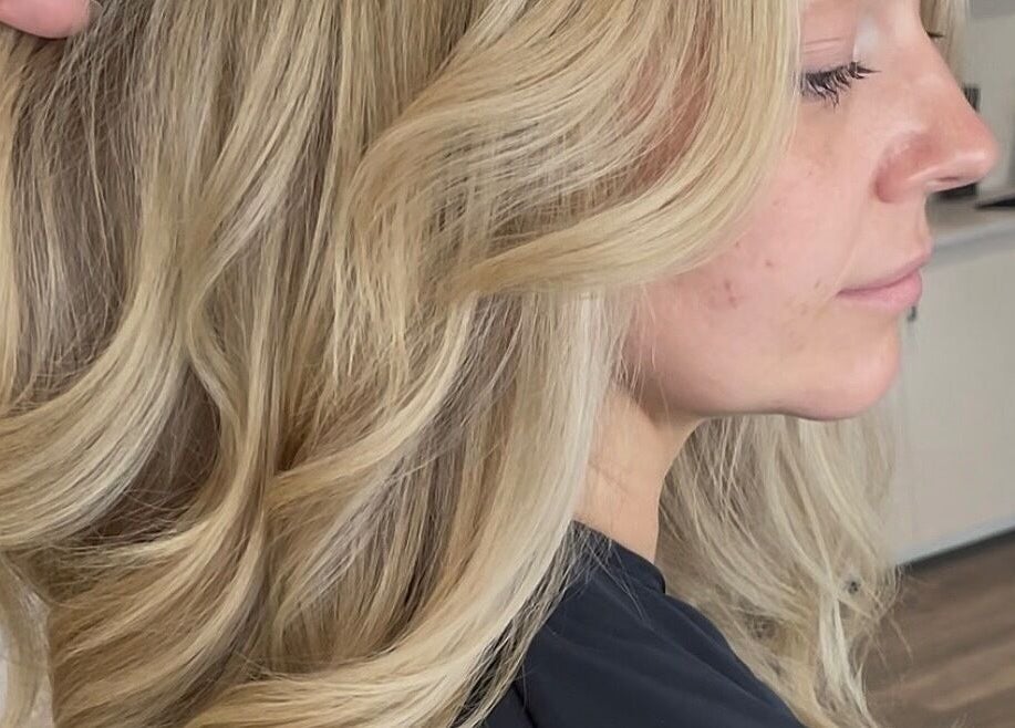 Blond hair styled in elegant waves at Chloe Jade Hair, Rogerstone, Newport, GB.