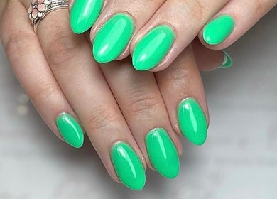 Vibrant green manicured nails at Olivia’s Beauty Studio in Hockley, England, GB.
