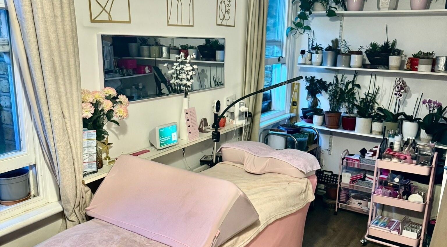 Relaxing treatment room at La Belle - Luxury Beauty by Patsy, London, England, GB, adorned with plants and decor.