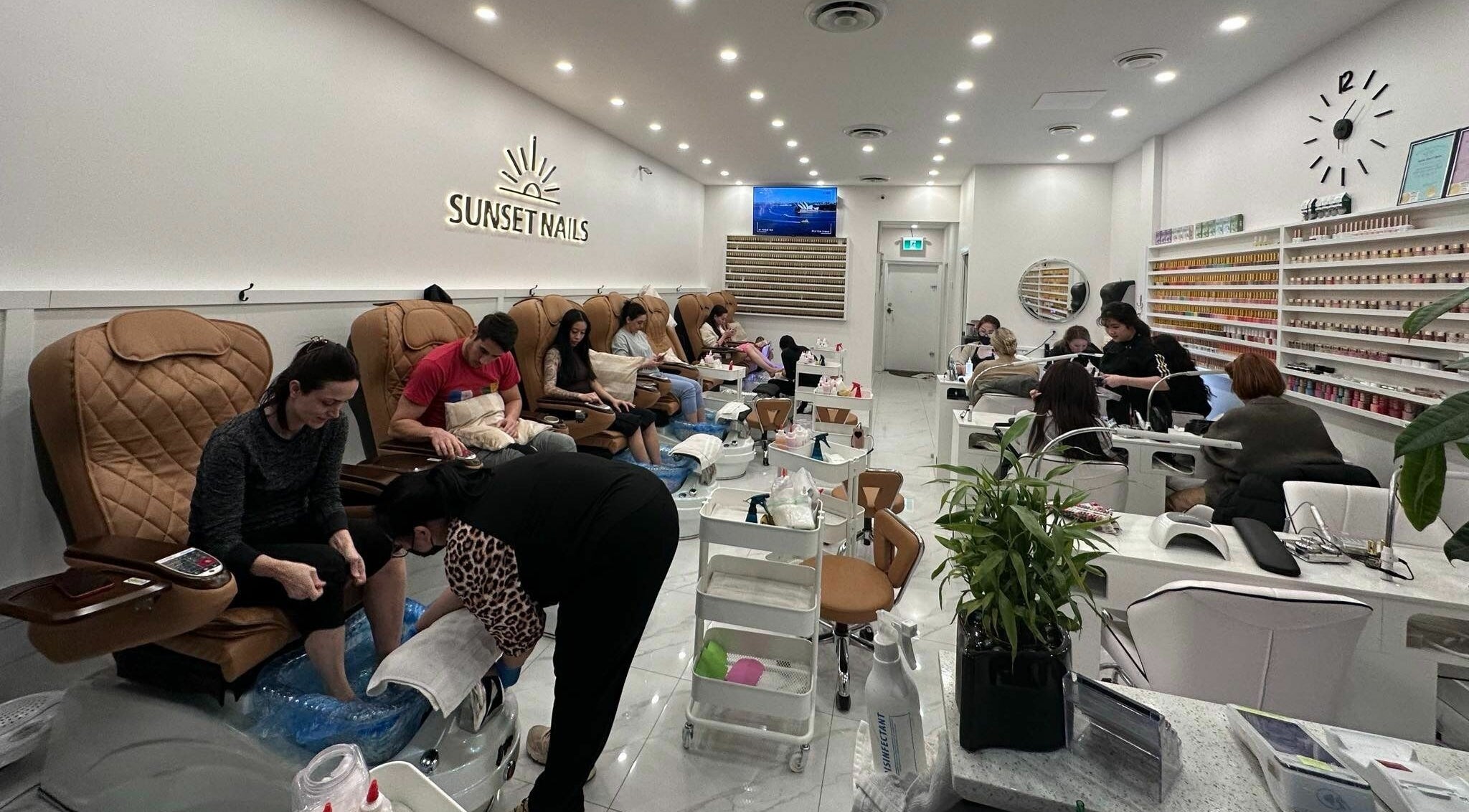 Clients enjoying pedicures at Sunset Nails in Vancouver, British Columbia, CA with cozy, vibrant interiors.