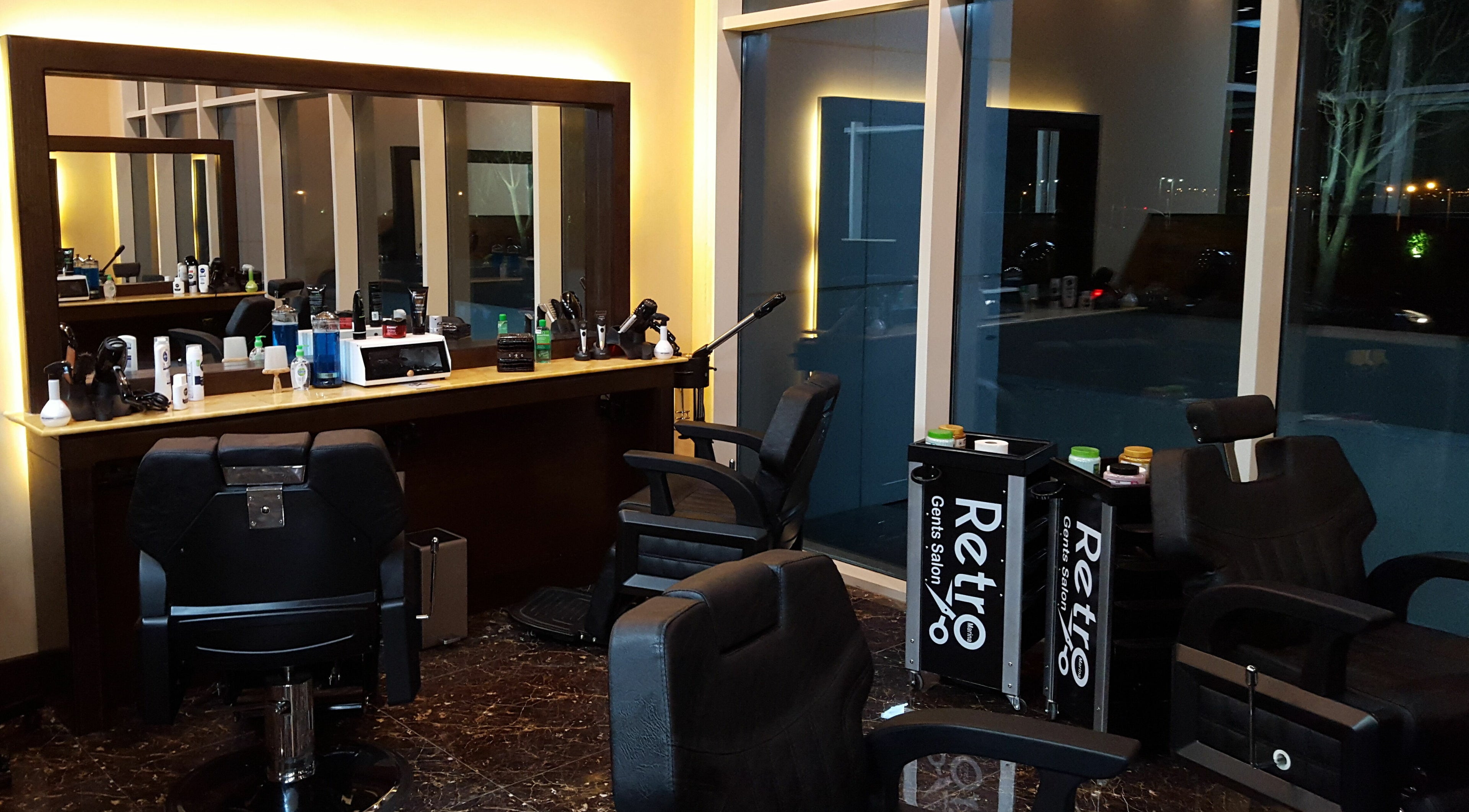 Interior of Retro Marina Gents Salon in Abu Dhabi, AE featuring modern barber chairs and stylish decor.