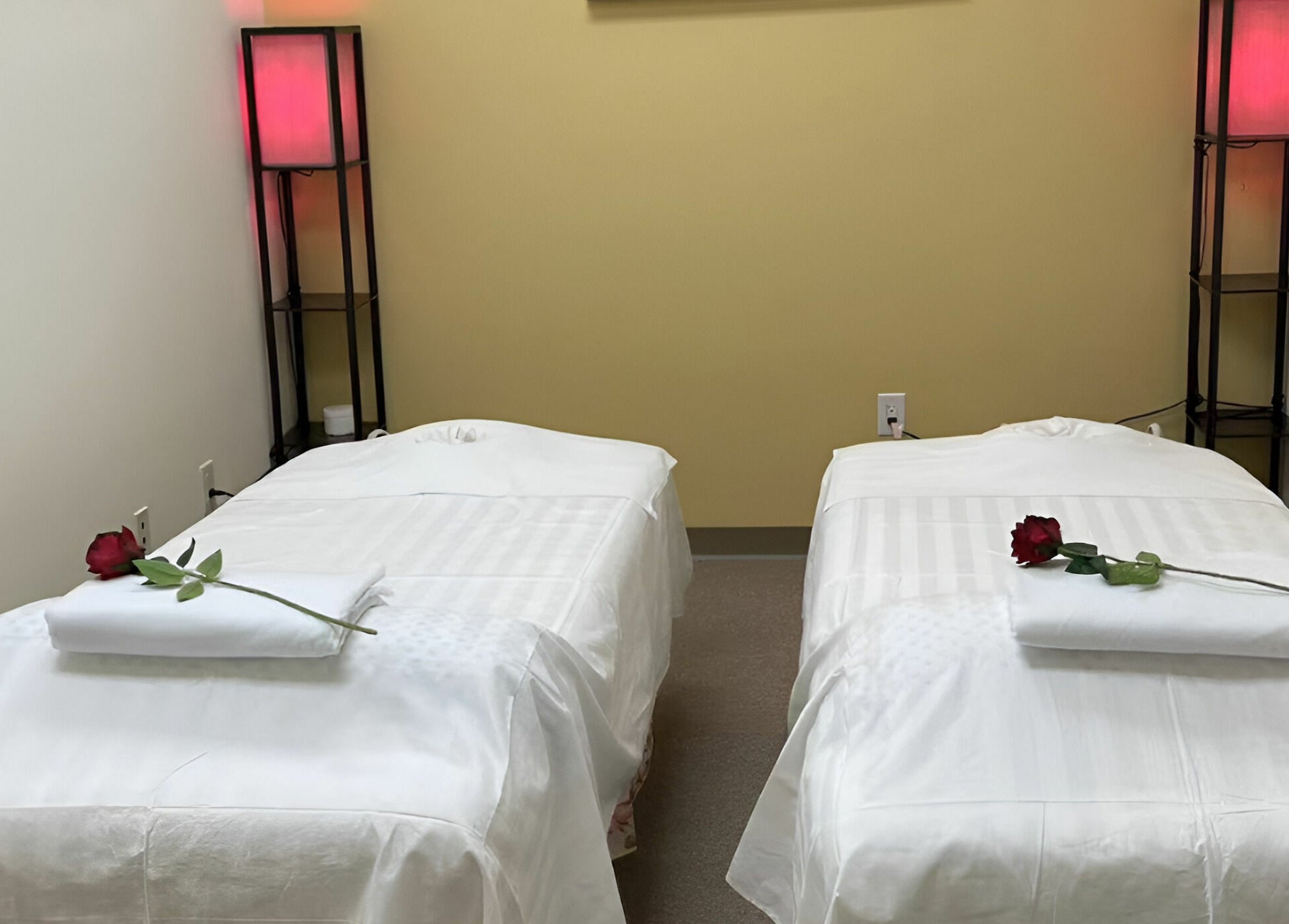 Luxurious couples massage room at Crystal Luxury Spa, Bristol, Virginia, US, featuring elegant decor and roses.