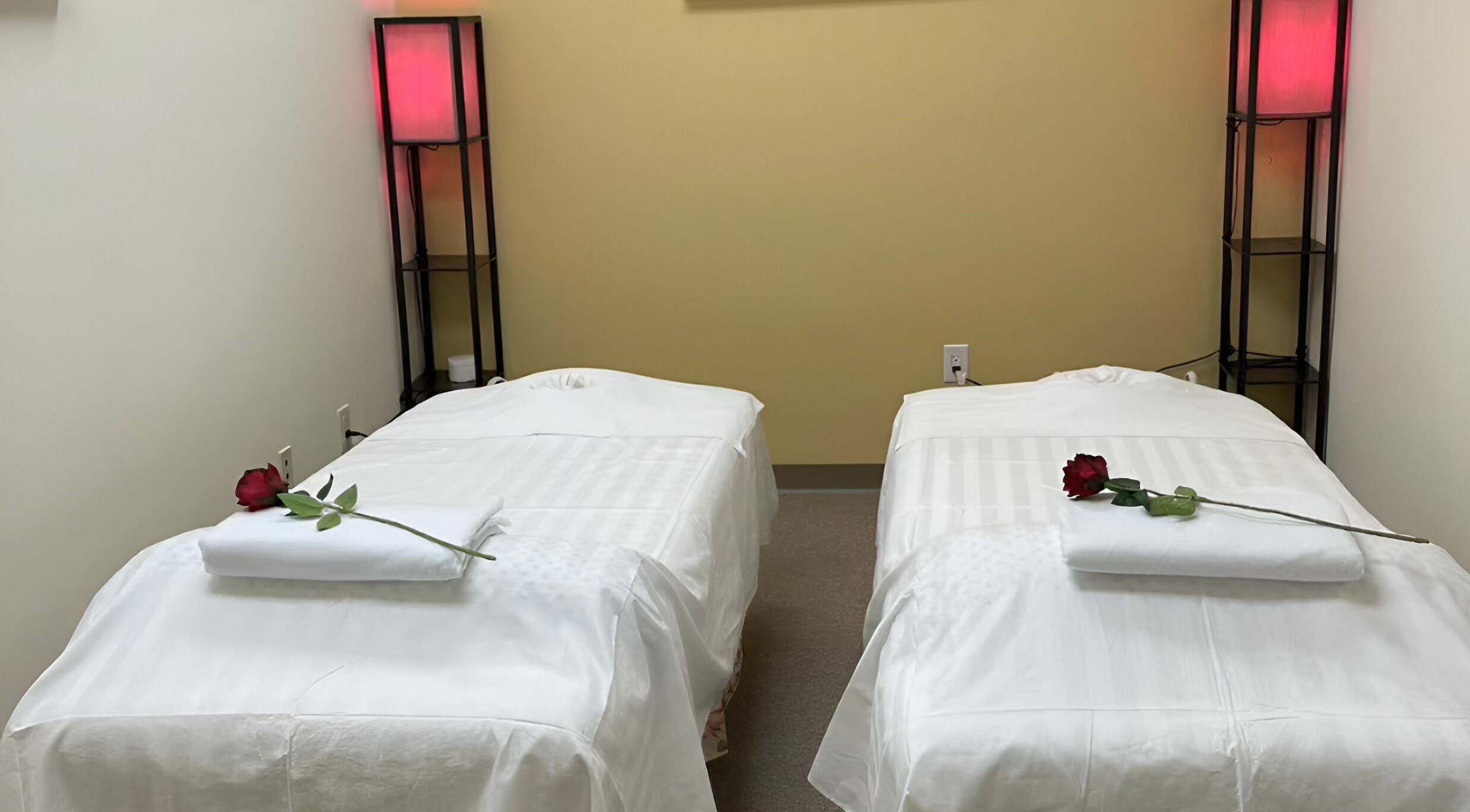 Luxurious couples massage room at Crystal Luxury Spa, Bristol, Virginia, US, featuring elegant decor and roses.