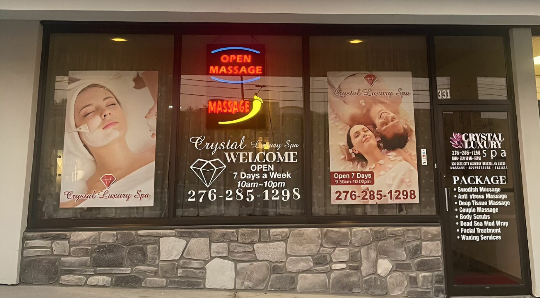 Front view of Crystal Luxury Spa in Bristol, Virginia with window displays promoting massage services.