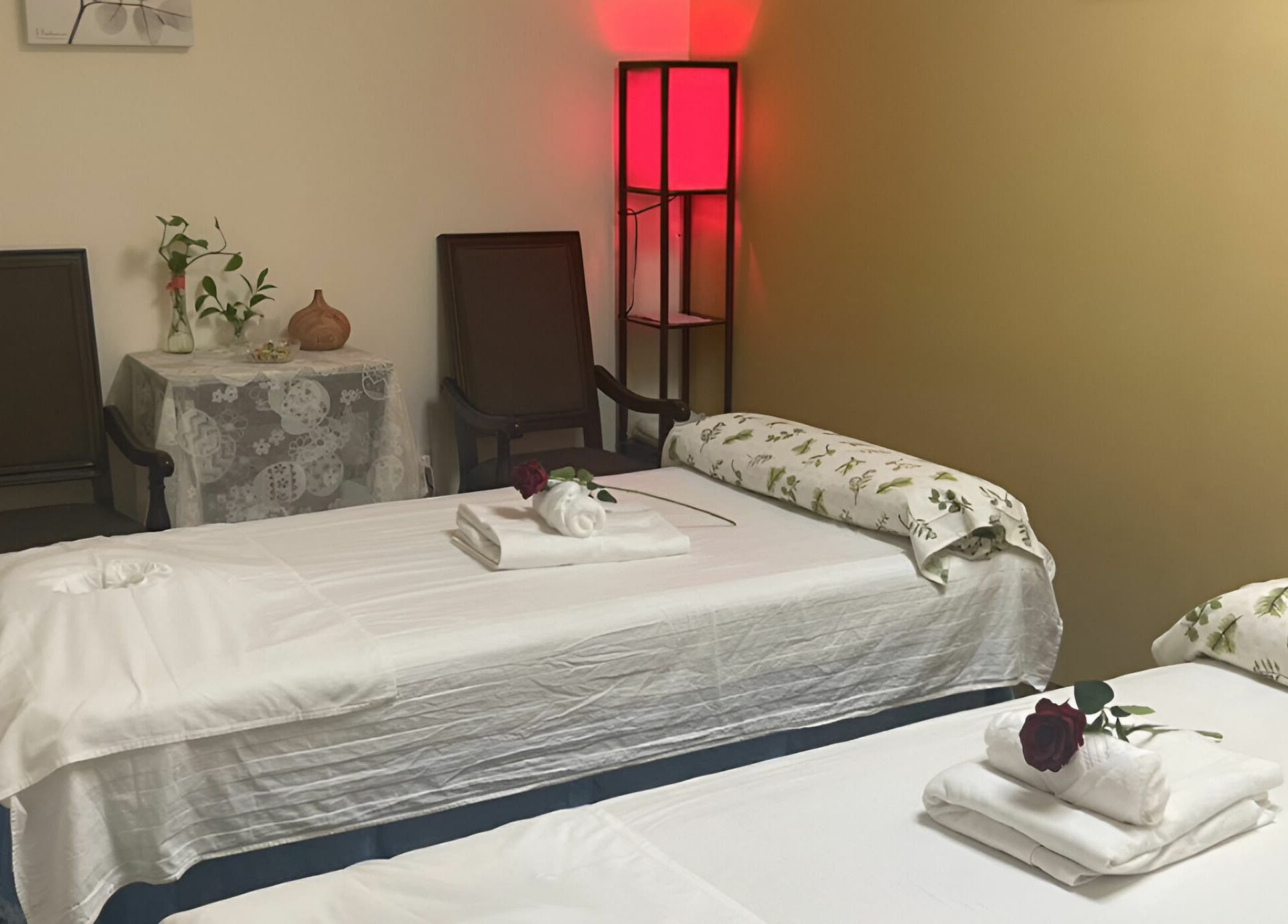 Relaxing therapy room at Crystal Luxury Spa, Bristol, Virginia, US, with two massage tables and calming decor.