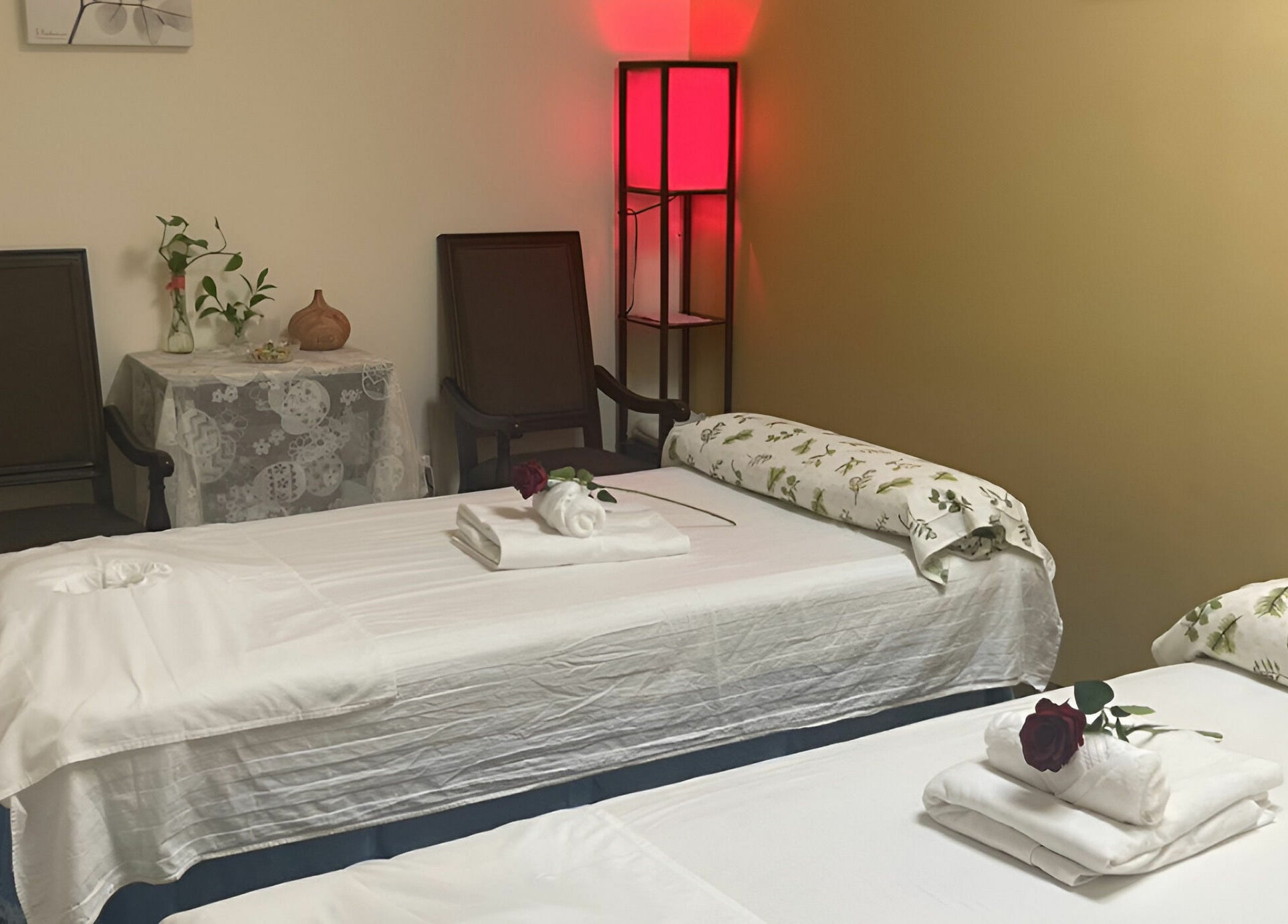 Relaxing therapy room at Crystal Luxury Spa, Bristol, Virginia, US, with two massage tables and calming decor.