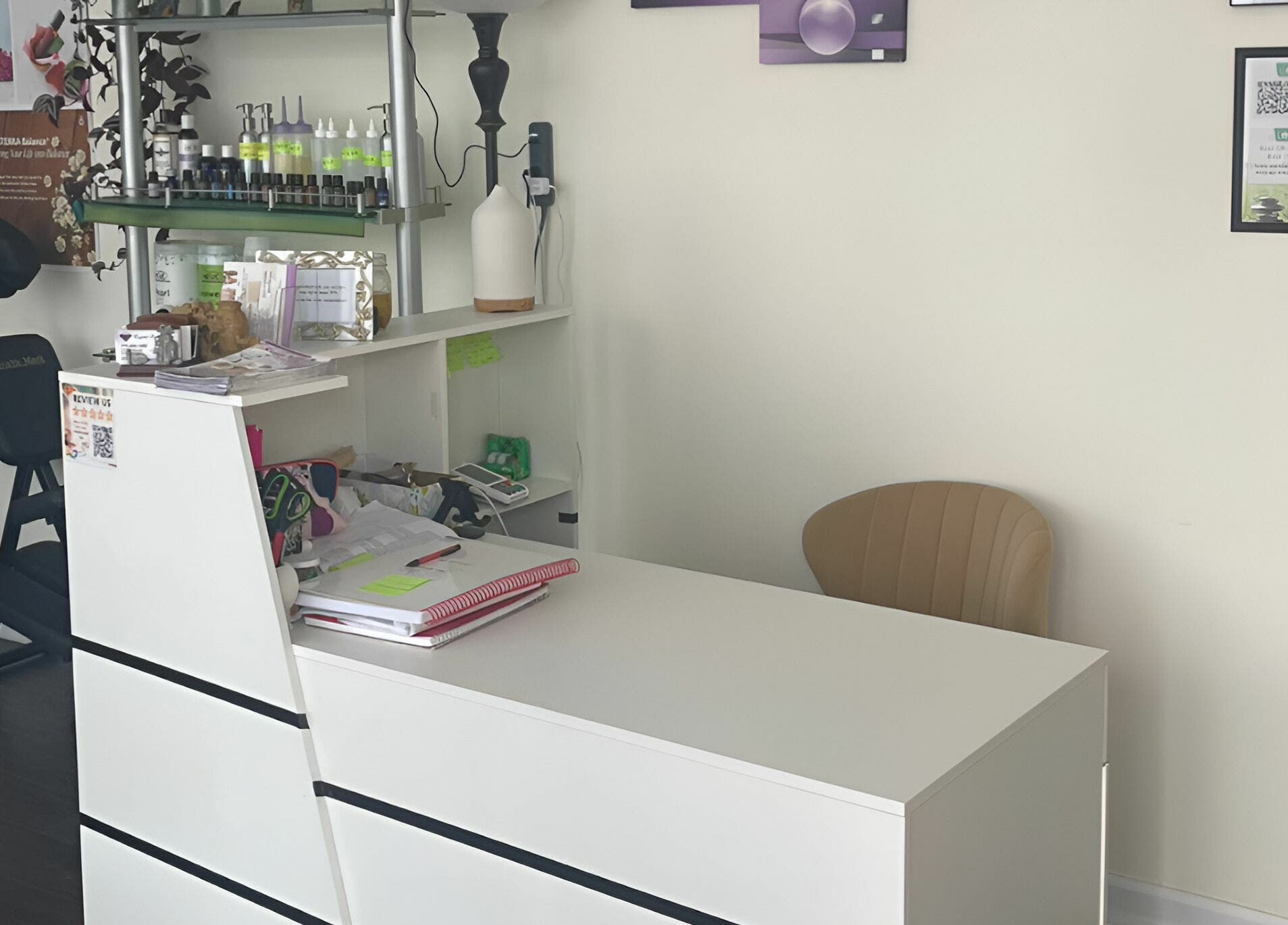 Reception desk at Crystal Luxury Spa, Bristol, Virginia with a relaxing ambiance and massage chair.