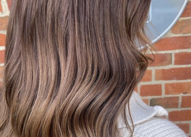 Smooth, wavy brown hair styled at Hair With Jess, Burton Upon Trent, England, GB, against a brick wall background.