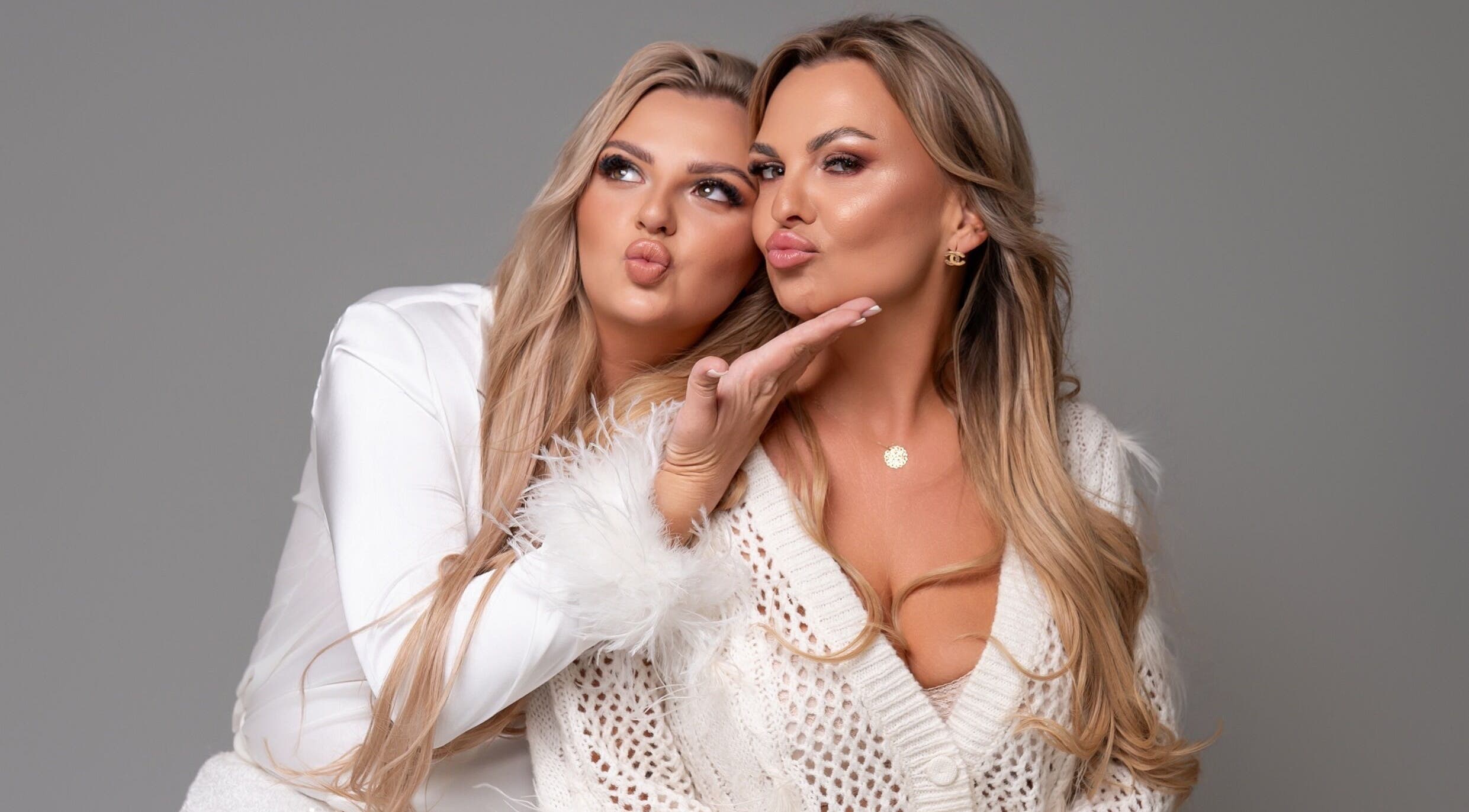 Two women pose playfully at Glam Room in Heywood, England, GB, showcasing styled hair and makeup.