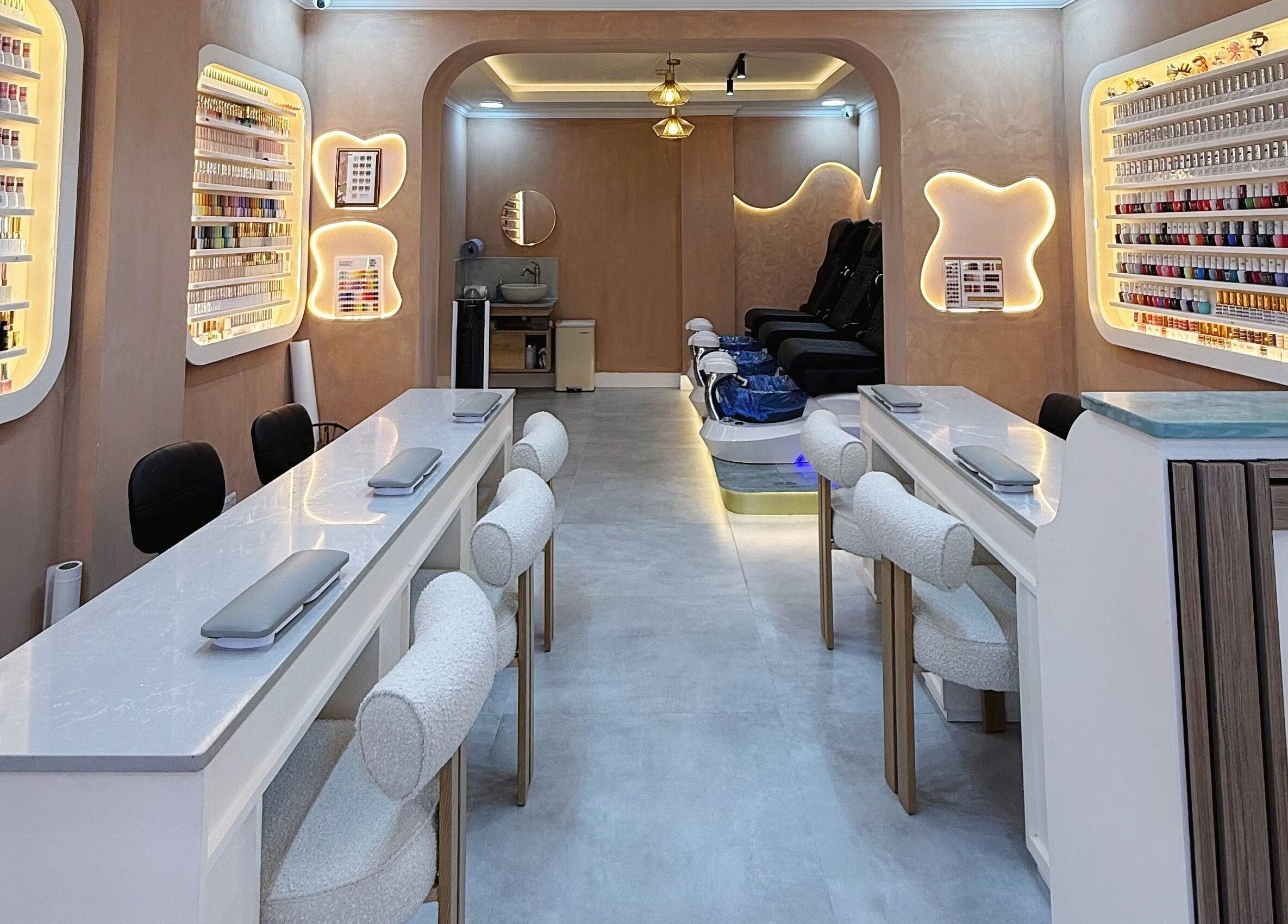 Luxurious nail salon interior at Natural Nails, London, England, GB, showcasing modern decor and cozy seating.