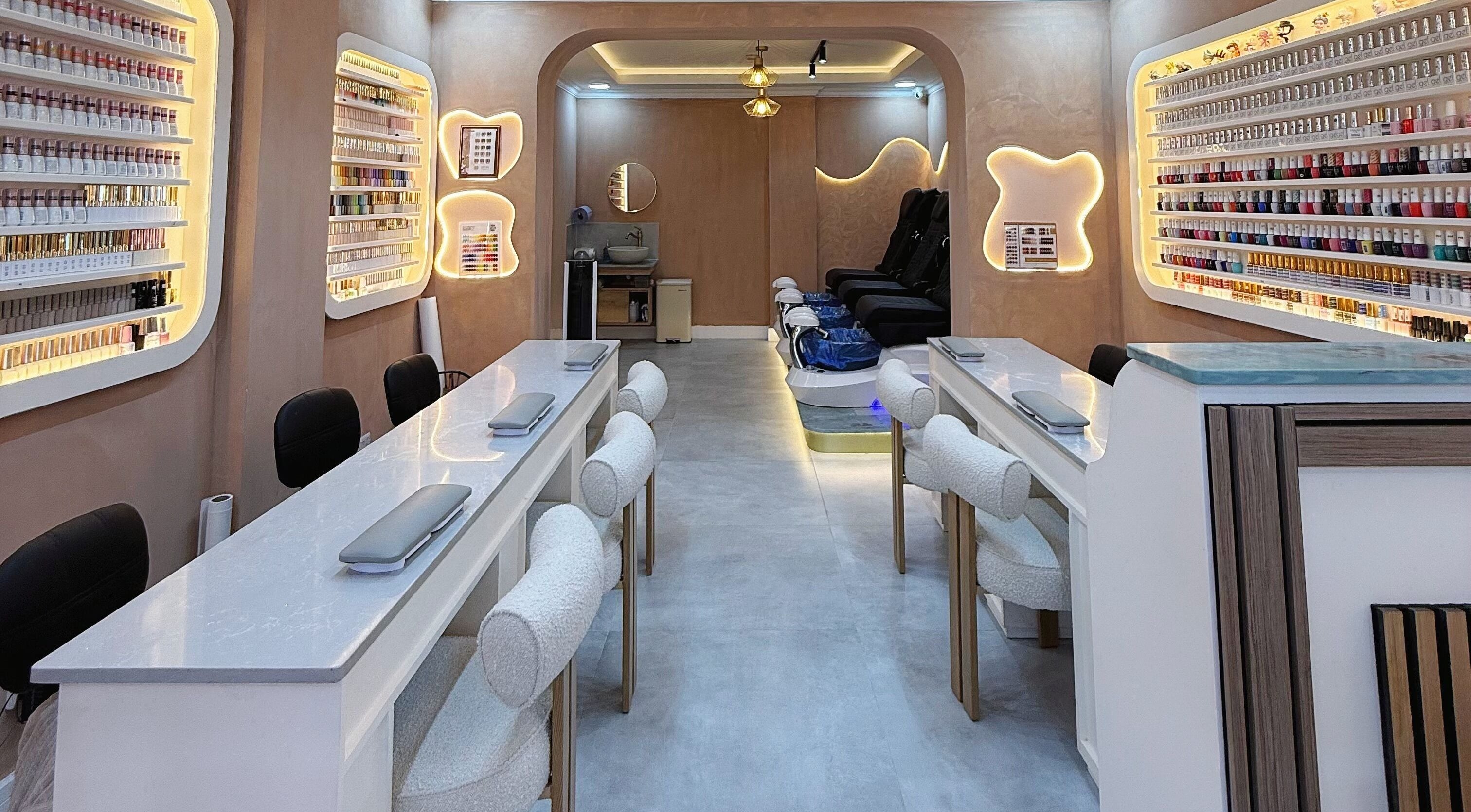Luxurious nail salon interior at Natural Nails, London, England, GB, showcasing modern decor and cozy seating.