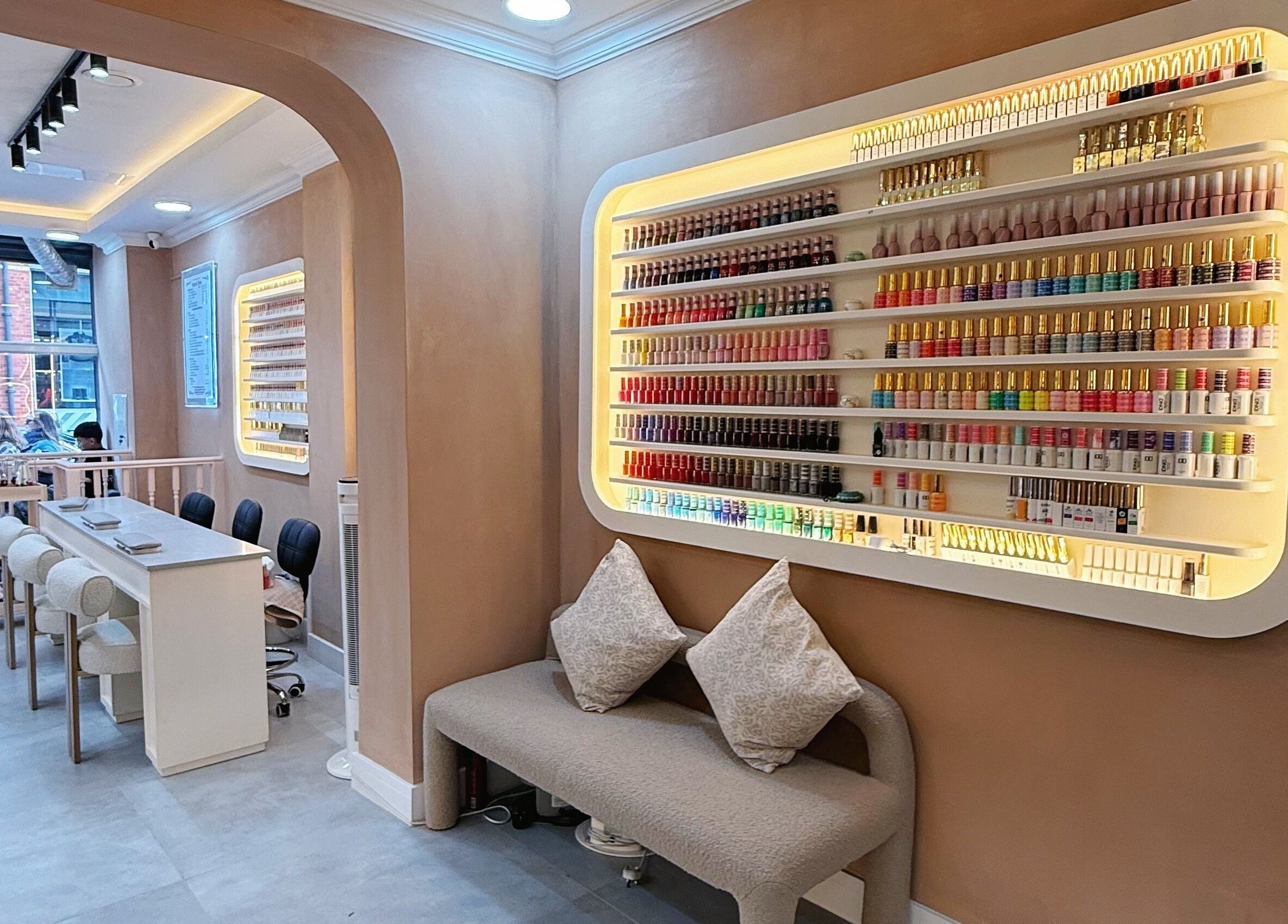 Interior of Natural Nails in London with cozy seating and colorful polish display.