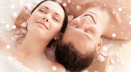 Couple enjoying spa treatment at Spring Leaf Spa, North Bethesda, Maryland, US, surrounded by rose petals.