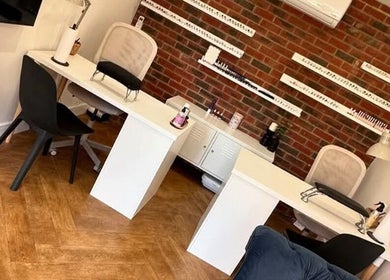 Elegant nail studio interior at Polished Nails, Portsmouth, England, featuring stylish manicure stations.
