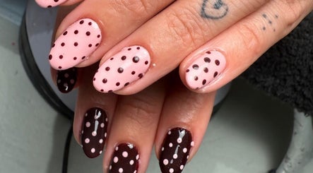 Stylish pink and dark nails with polka dots at Polished Nails, Portsmouth, England, GB.