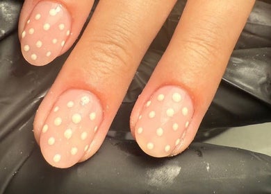 Polished Nails in Portsmouth, England, GB showcasing elegant nude nails with white polka dots.